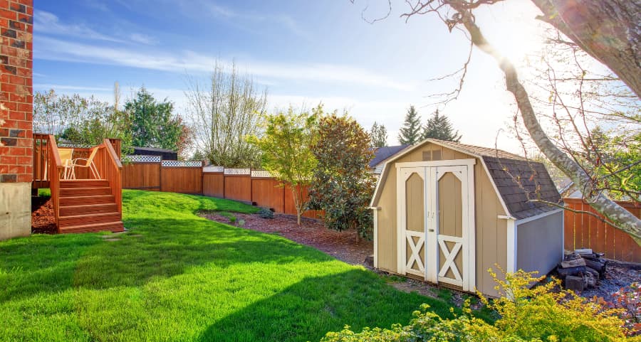 Fenced backyard with storage shed in St. Louis